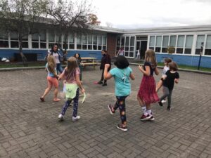 students in a circle dancing