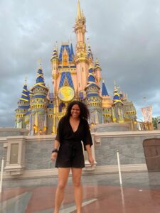 Gabrielle Holland standing in front of Disney castle