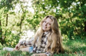 LeiLani Markley resting in a field